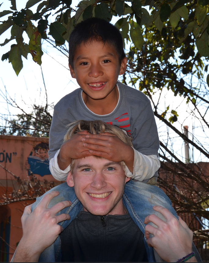 Miami student with boy in Guatemala