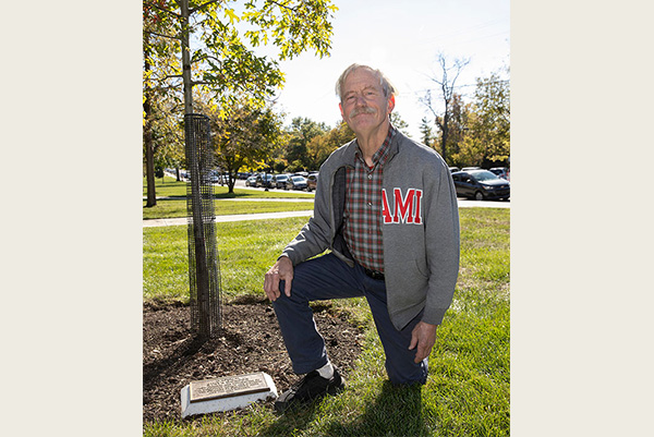 Steve Gordon next to a young oak tree