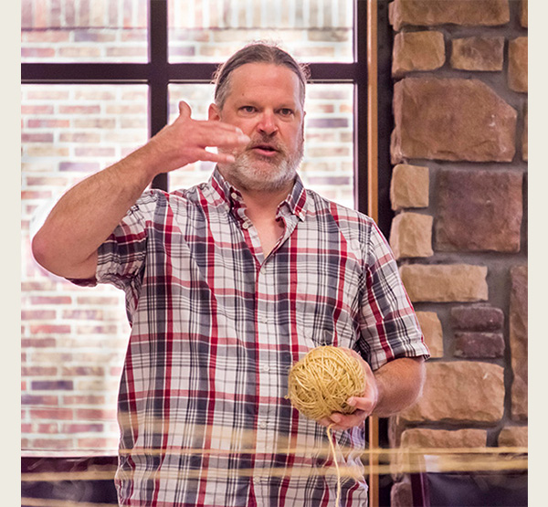 Joshua Sutterfield holds a ball of twine during a community web activity in Miami, Oklahoma (photo courtesy of the Miami Tribe of Oklahoma).