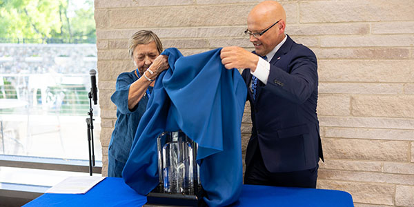 Ann Walton, left, president of the Western College Alumnae Association Board of Trustees, and Miami University President Gregory Crawford unveil the Freedom Summer of '64 Award during a ceremony on June 7 at Western Dining Commons.