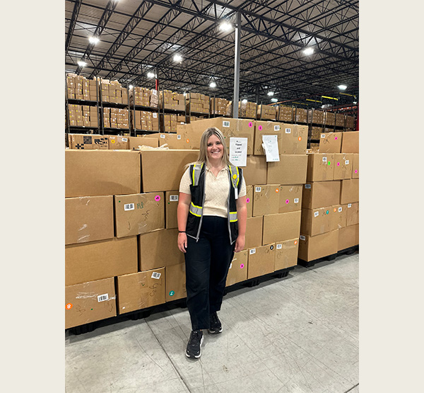 Isabelle Campbell standing in the warehouse area she organized.