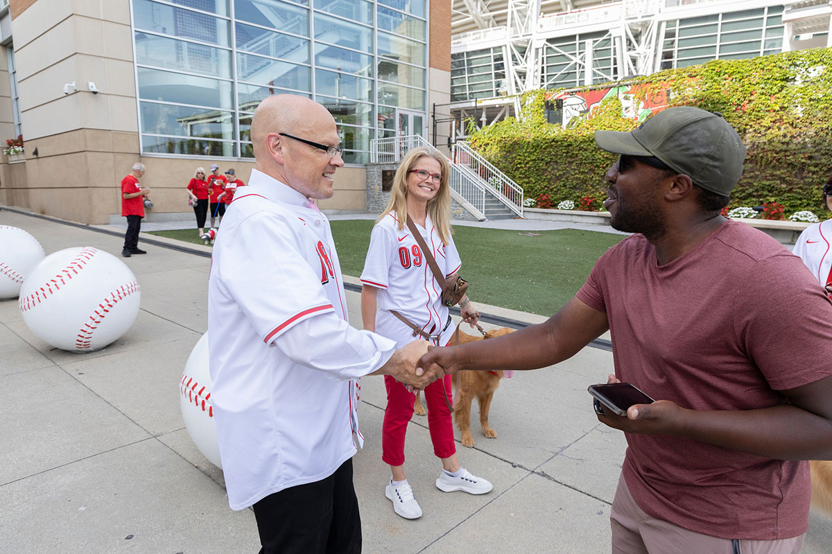 Miami University President Greg Crawford and University Ambassador Dr. Renate Crawford at Great American Ball Park's Bark in the Park with their dogs, Newton and Ivy