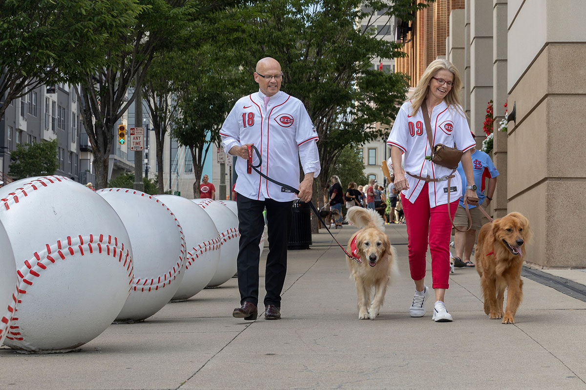 Miami University President Greg Crawford and University Ambassador Dr. Renate Crawford at Great American Ball Park's Bark in the Park with their dogs, Ivy and Newton