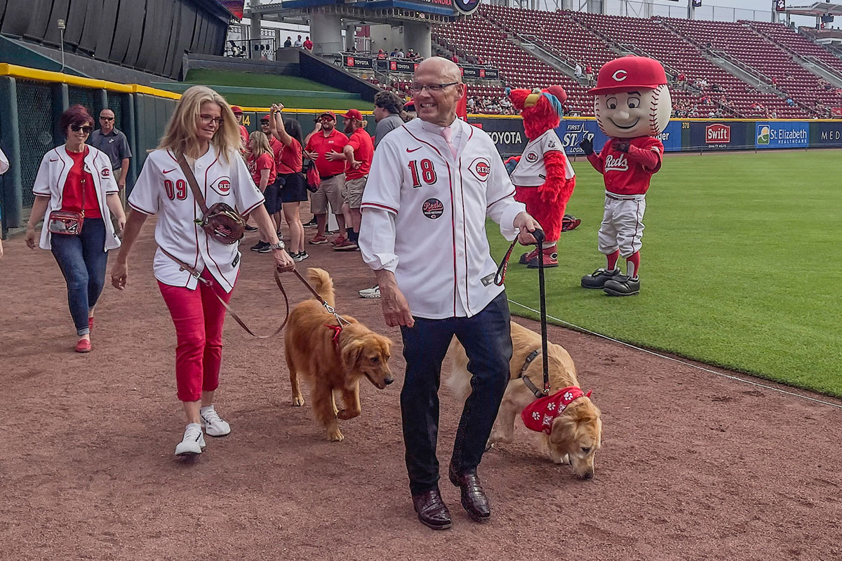 Miami University President Greg Crawford and University Ambassador Dr. Renate Crawford at Great American Ball Park's Bark in the Park with their dogs, Newton and Ivy