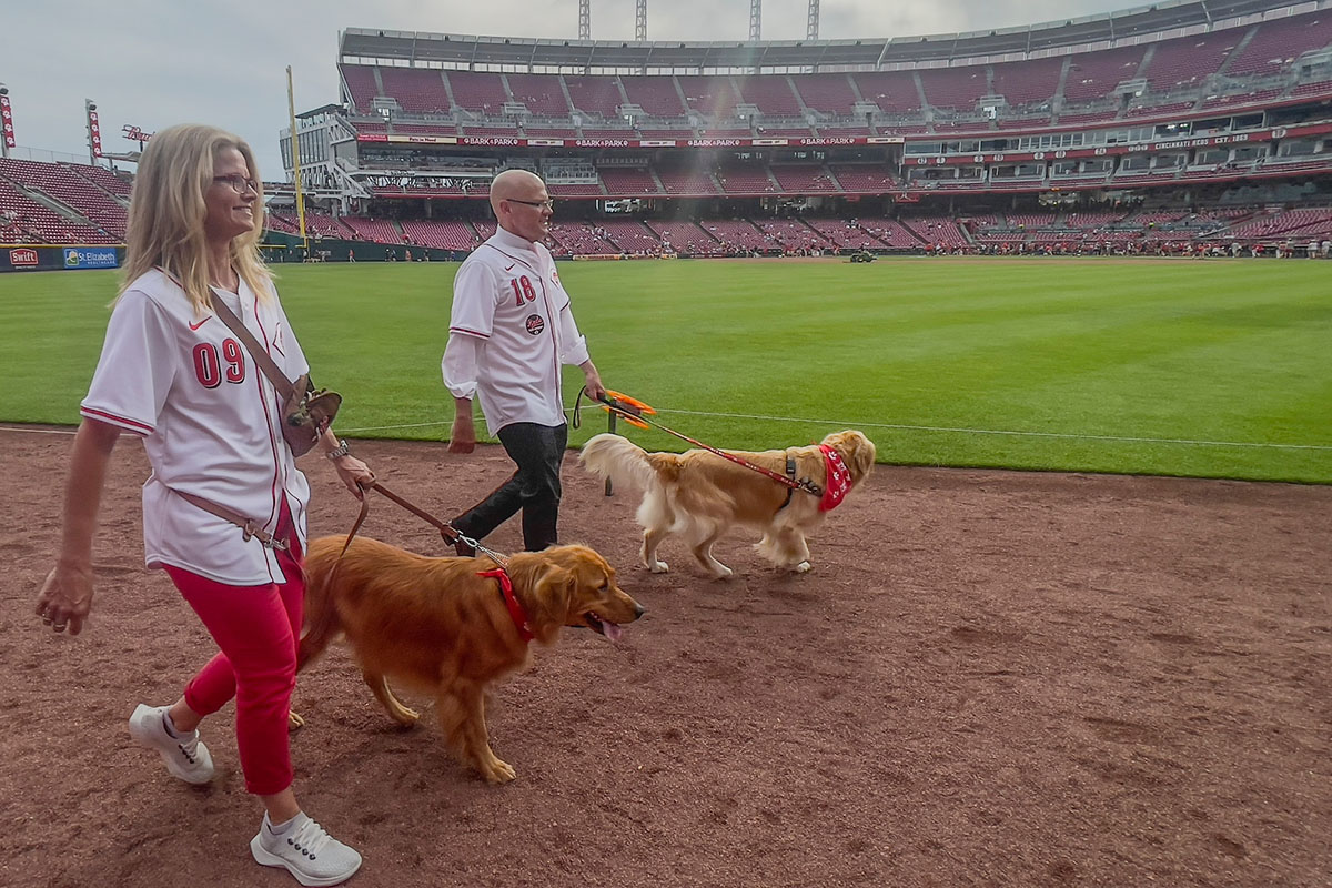 Miami University President Greg Crawford and University Ambassador Dr. Renate Crawford at Great American Ball Park's Bark in the Park with their dogs, Newton and Ivy