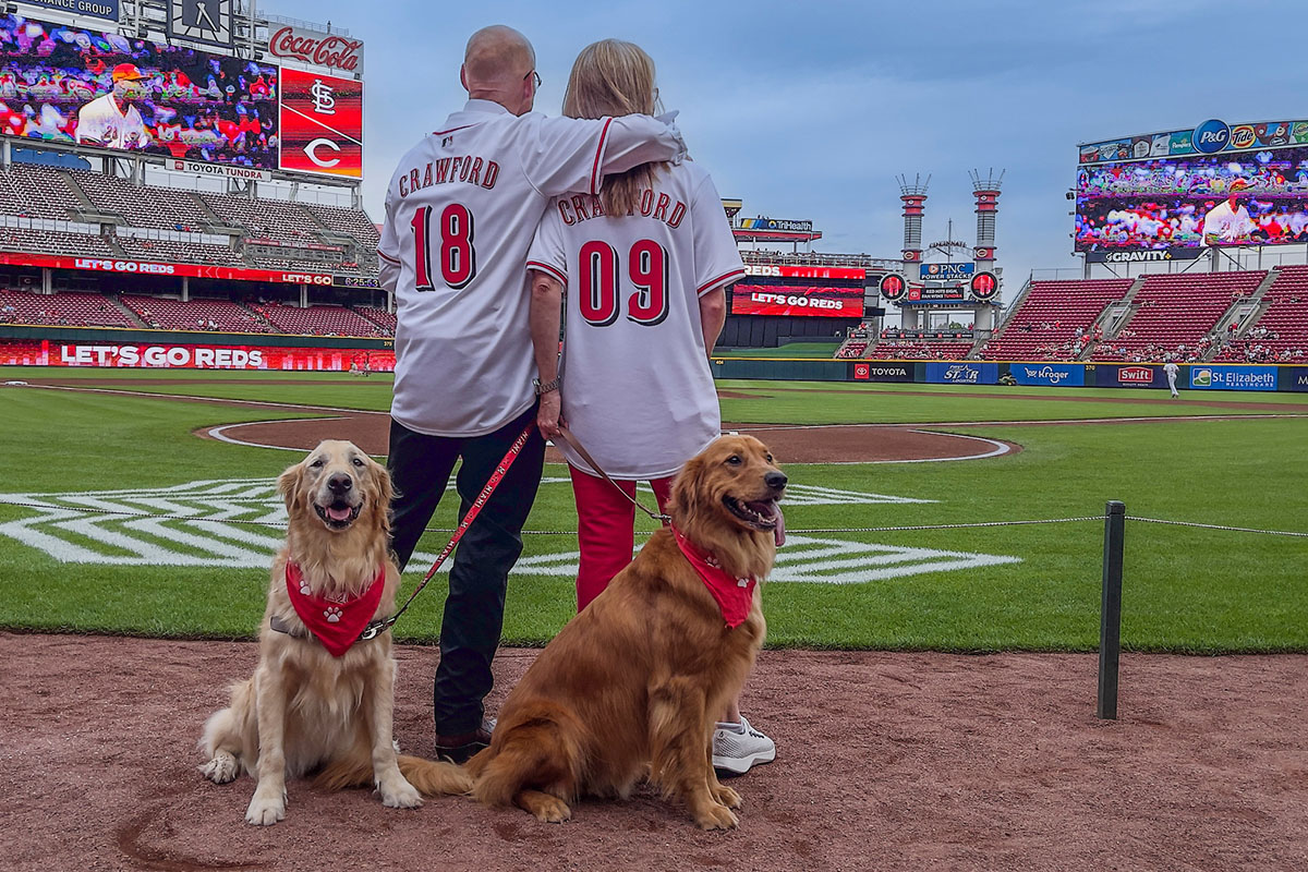 Miami University President Greg Crawford and University Ambassador Dr. Renate Crawford at Great American Ball Park's Bark in the Park with their dogs, Newton and Ivy