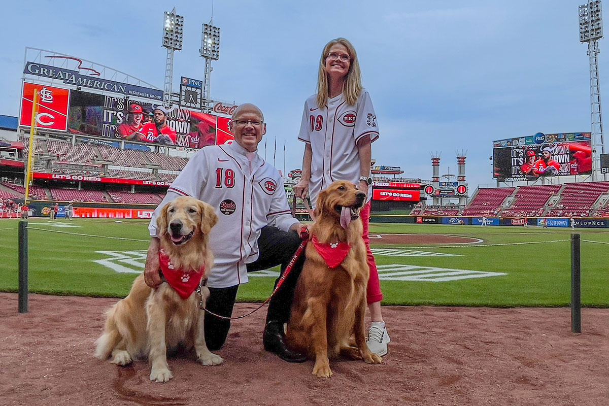 Miami University President Greg Crawford and University Ambassador Dr. Renate Crawford at Great American Ball Park's Bark in the Park with their dogs, Newton and Ivy