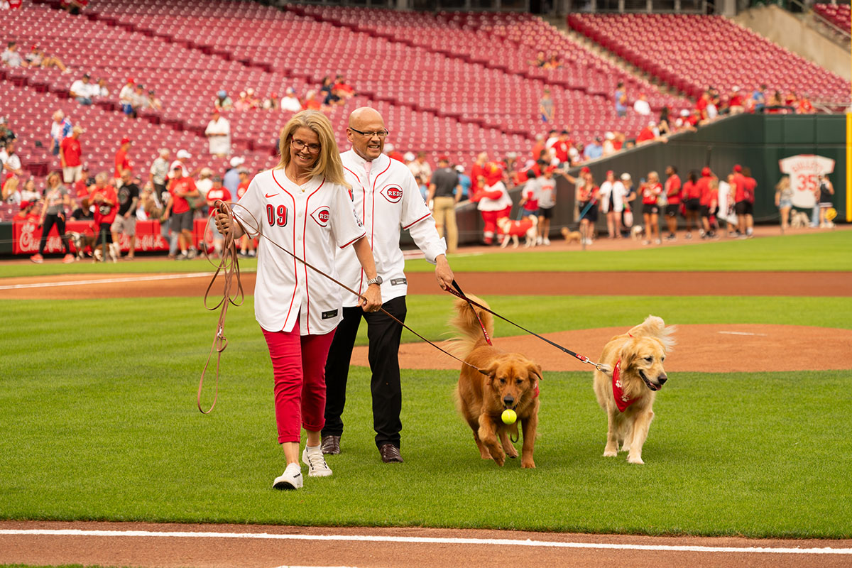 Miami University President Greg Crawford and University Ambassador Dr. Renate Crawford at Great American Ball Park's Bark in the Park with their dogs, Newton and Ivy