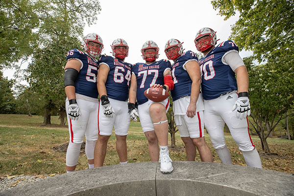 Miami University football players wearing Western College-themed jerseys pose on the Western campus of Miami University.