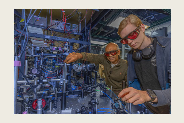 Samir Bali, left, professor of Physics, works in his lab with student Caden McCollum. (Photo by Scott Kissell)