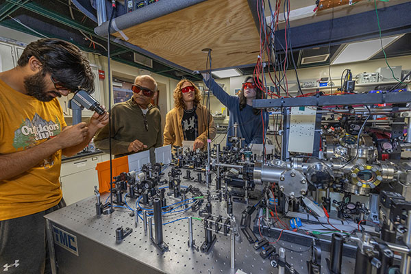 Chanakya Pandya, left, Samir Bali, Andy Zabinski, and Nikolus Miller work in Bali's lab in Kreger Hall.