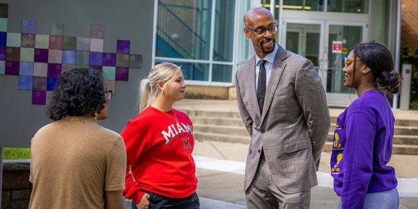 Ande Durojaiye, vice president of Miami Regionals and dean of the College of Liberal Arts and Applied Science, speaks with participants of the Early College Academy.