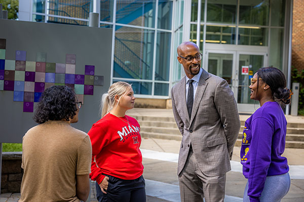 Ande Durojaiye, vice president of Miami Regionals and dean of the College of Liberal Arts and Applied Science, speaks with participants of the Early College Academy.