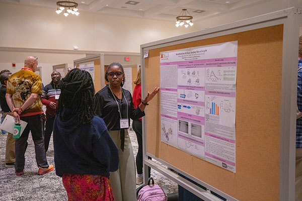 two graduate students at a poster presentation during the graduate research forum