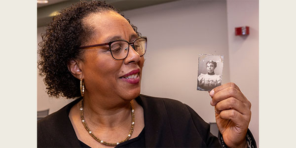 Melanie Walker looks at a photograph of her great-grandmother, Nellie Craig Walker, Miami University's first Black graduate