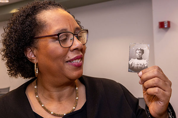 Melanie Walker looks at a photograph of her great-grandmother, Nellie Craig Walker, Miami University's first Black graduate