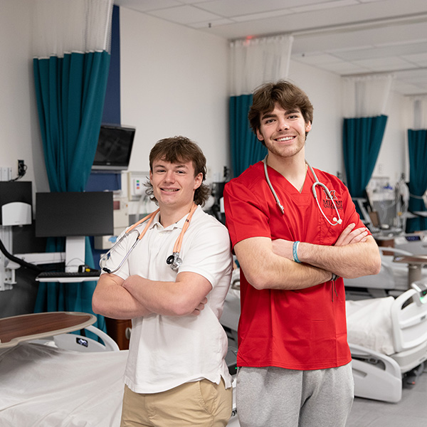 Brayden Osborne stands with Reed Stewart in the Nursing Lab at the Miami University Regionals campus in Hamilton.