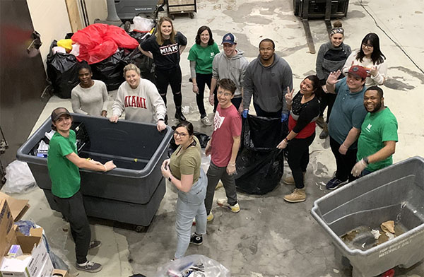 A group of student volunteers sort waste and recycling during GameDay March 2020