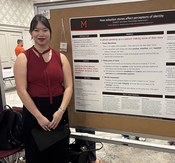 Ann Bixel stands next to her research poster in Shriver center 