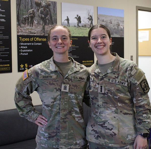Army ROTC cadet Haley Martin (left), cadet command sergeant major for the battalion, stands with Army ROTC Redhawk Company Commander Hope Keith).