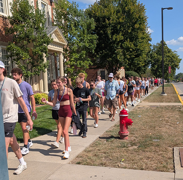 a large group of students walks along High Street across from the Slant Walk gate during the Suicide Prevention Walk last year 